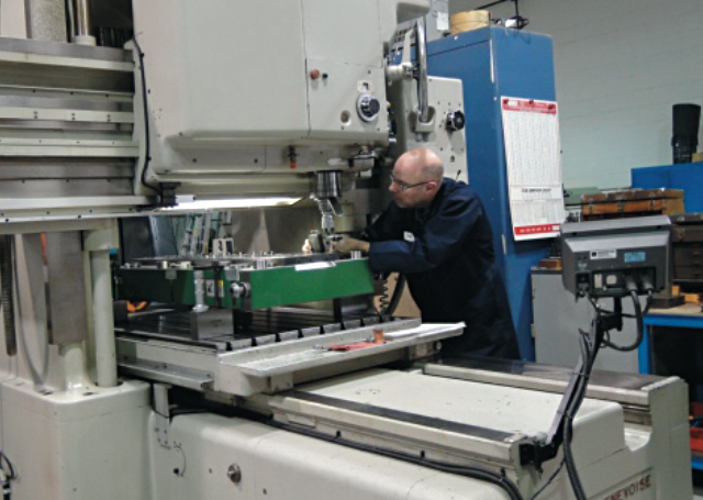 Robert Cattle, Executive Director, CTMA, works on a machine at MicroMetric
