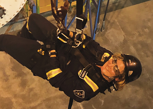 Firefighter Debra Rogers of the Campbell River Fire Dept in Britiish Columbia rappelling in full uniform.